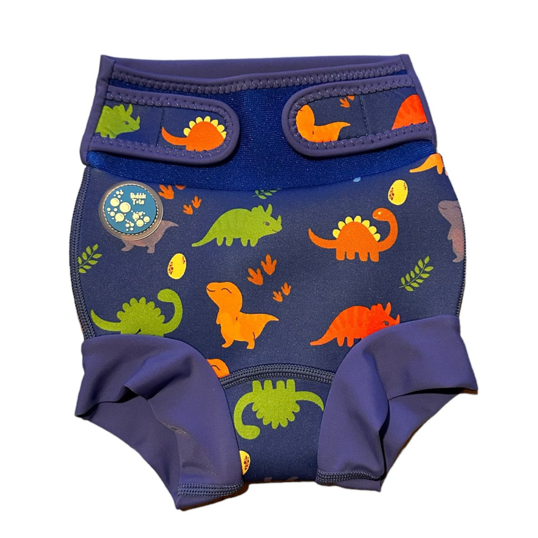 Bubble Tots Go Anywhere Swim Nappy Blue Dinosaurs Design An image of the Bubble Tots Go Anywhere Swim Nappy in Blue Dinosaurs design. The design features playful Dinosaurs, Eggs and Prints. 