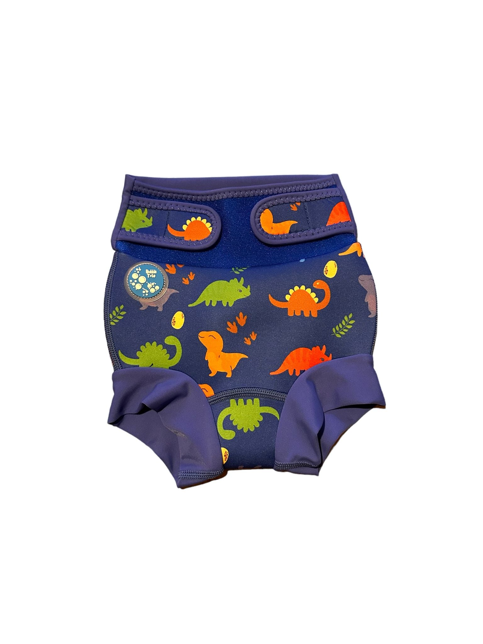 Bubble Tots Go Anywhere Swim Nappy Blue Dinosaurs Design An image of the Bubble Tots Go Anywhere Swim Nappy in Blue Dinosaurs design. The design features playful Dinosaurs, Eggs and Prints. 